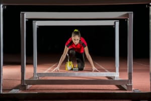 Woman Ready to Jump Hurdles (that Could Metaphorically Prevent Her from Getting Porcelain Veneers_