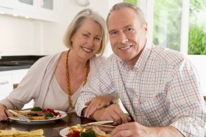 happy senior couple enjoys meal